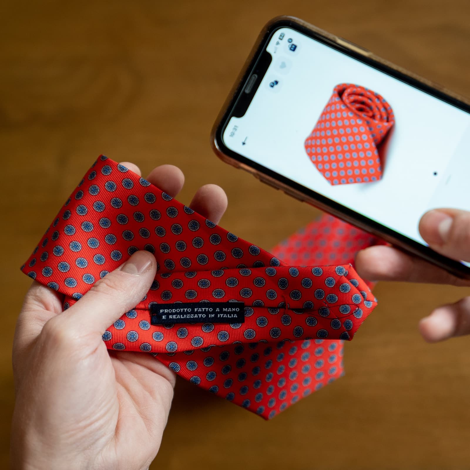 Two bespoke shirts on wooden forms inside an Italian tailoring atelier.
